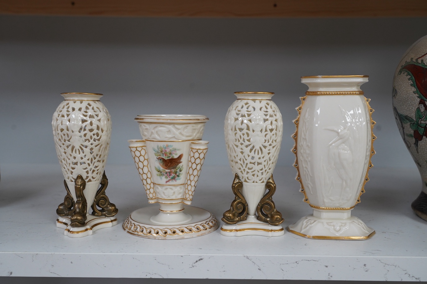 A pair of Royal Worcester or Grainger and Co. pierced urns and two other Worcester vases, tallest 16cm. Condition - good, some wear